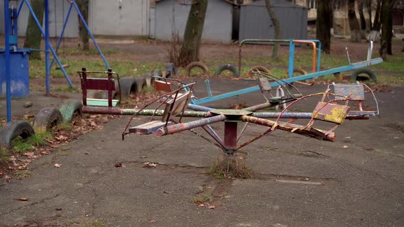 An Old Carousel Rotates in the Playground