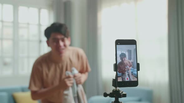 Display Smartphone Of Asian Man Shows Trick With Disappearing While Recording Video Content In Home