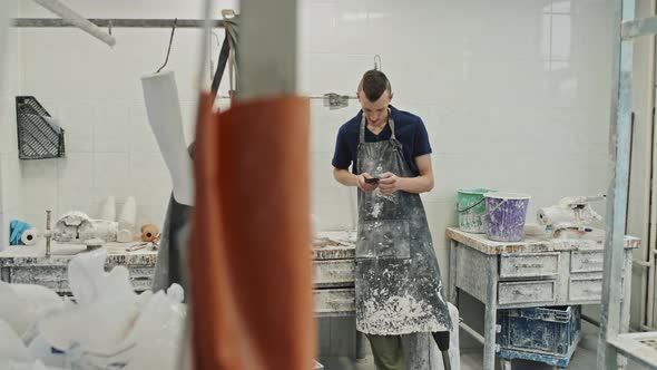 Craftsman Using Smartphone At Work