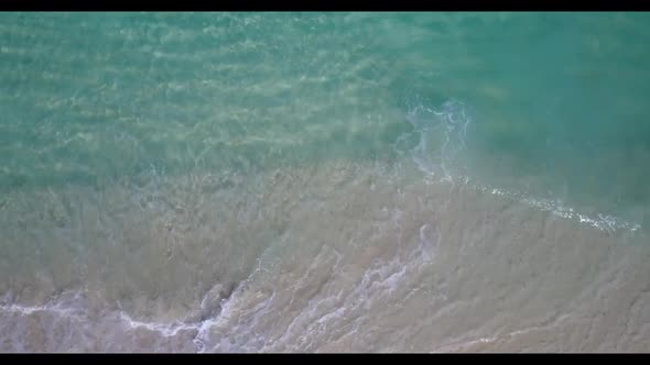 Aerial drone texture of luxury seashore beach adventure by blue water with white sandy background of