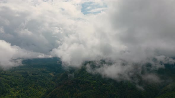 Aerial time lapse of fog over hills after rain