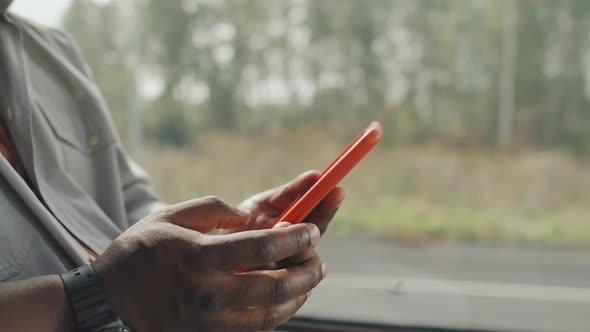 Male Hands Using Smartphone during Bus Ride