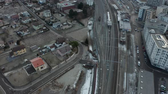 Aerial of large trainyard near city in winter