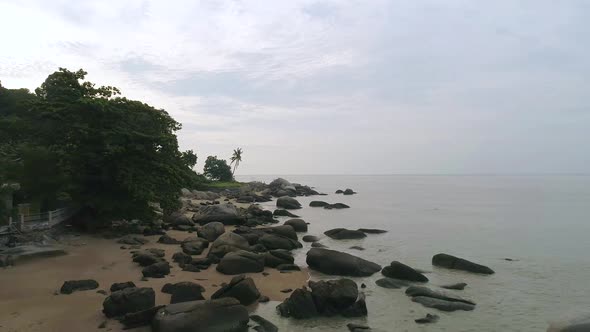 A drone shot of giant boulders at Shamrock Beach at Penang, Malaysia.