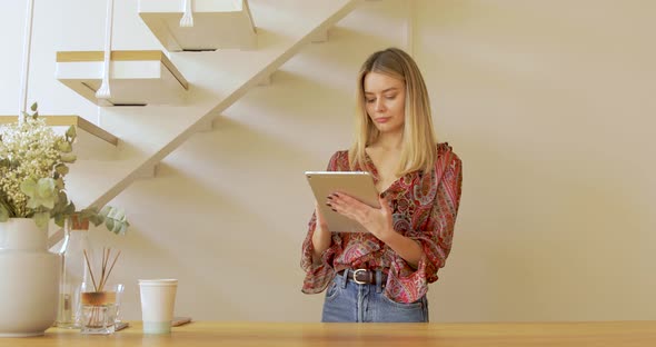 Small Business Owner In Clothes Shop Working On Digital Tablet