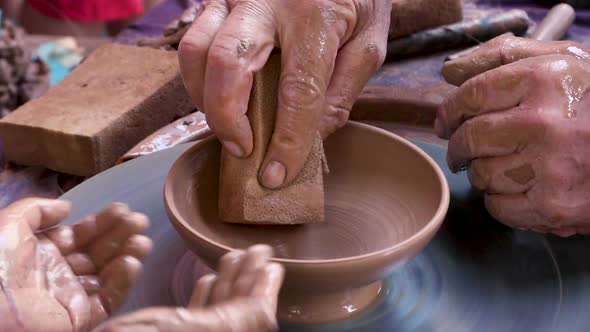 Potter at Work Teaching Young Student