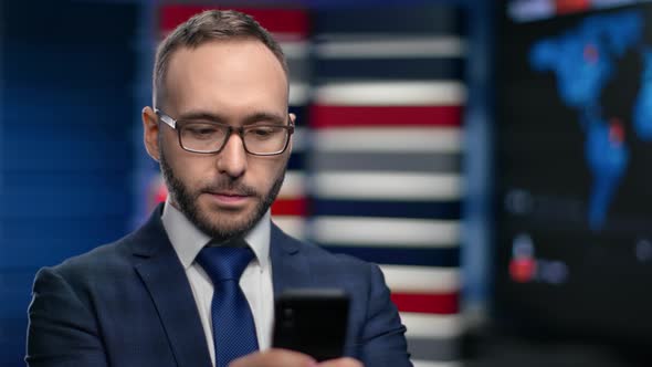 Focused Male Boss in Tie Suit Thinking Chatting Typing Message Use Smartphone at Hi Tech Office