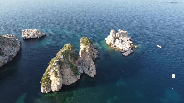 Faraglioni, Stacks Of Scopello By The Calm Water Of Castellammare Del Golfo In Trapani, Sicily, Ital