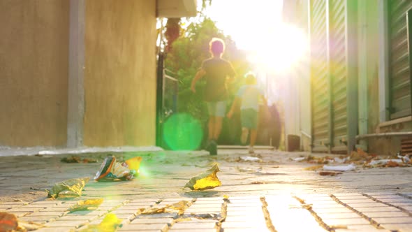 Boys running in bright sunlight Autumn scene