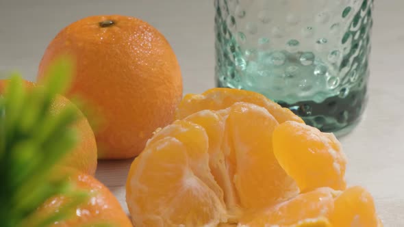Tilt down Orange Mandarin fruits with juice glass on White table - Heathy Nutrition