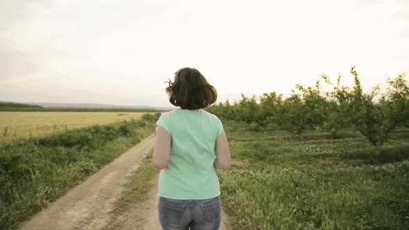 Young Caucasian Woman Enjoying Life And Running Jogging In Spanish Countryside Road Through Rural