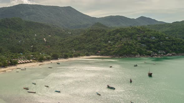 Beautiful tropical beach with boats on a sea in Koh Phangan island, Thailand