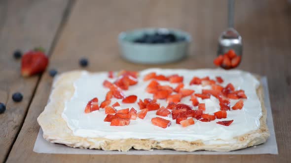 Process of making meringue roulade with summer berries