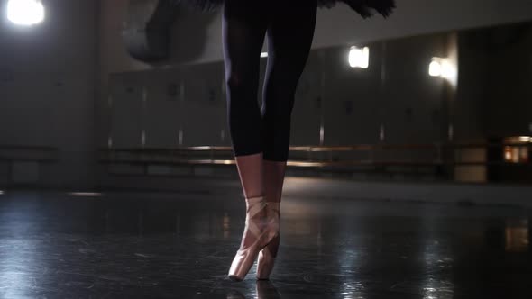 Ballet Dancing  Woman Ballerina in Black Tutu Walks on the Tips of Pointe Shoes