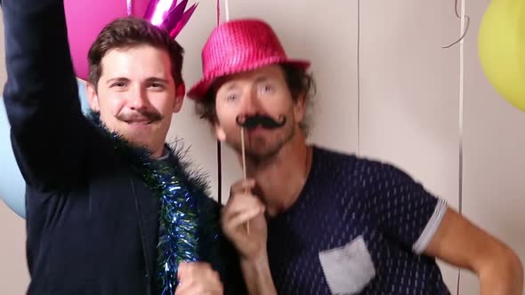 Two men dancing in photo booth