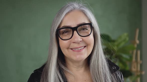  Stylish Retired Woman with Gray Hair Wearing Glasses and Looking at Camera with Happy Face