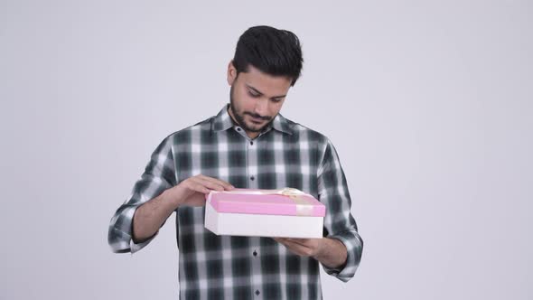 Young Happy Bearded Indian Man Opening Gift Box