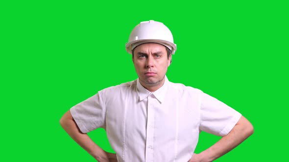 Young Male Engineer Standing and Smiling on Green Screen Background