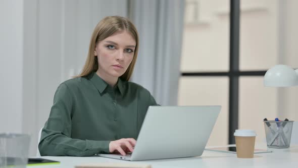 Young Woman Feeling Shocked While Using Laptop 