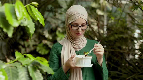 Cheerful Muslim Woman Eating Healthy Lunch in Spa
