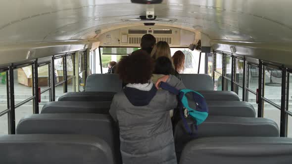 Masked Multiethnic Pupils Getting Off School Bus