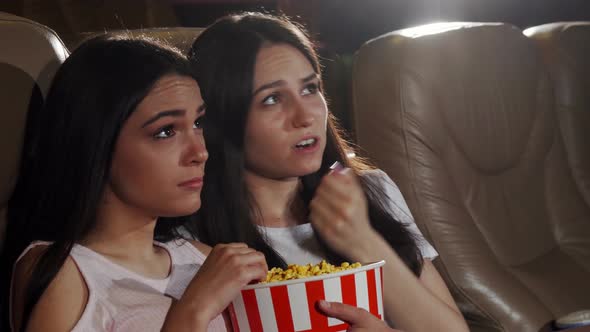 Female Friends Watching Dramatic Movie Together