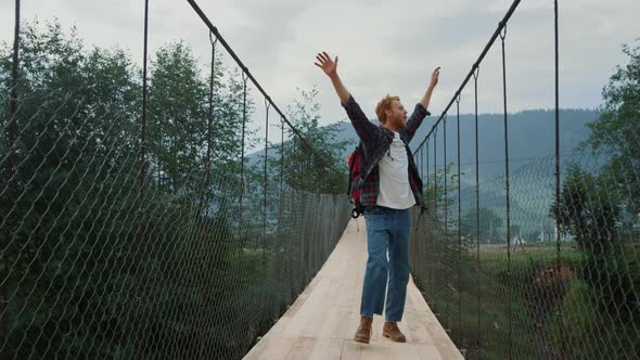 Carefree Guy Explore Nature on Mountains River Bridge