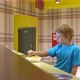 Blonde boy with relish eats french fries in the cafe - VideoHive Item for Sale