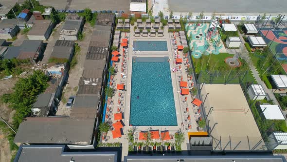 Drone Aerial View People Swim in Pool on Territory Modern Residential Complex