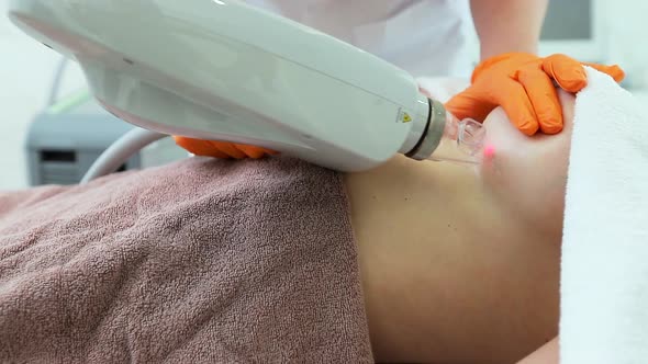 Woman Getting a Laser Skin Treatment or Laser Resurfacing of Scars in a Skincare Cosmetology Clinic