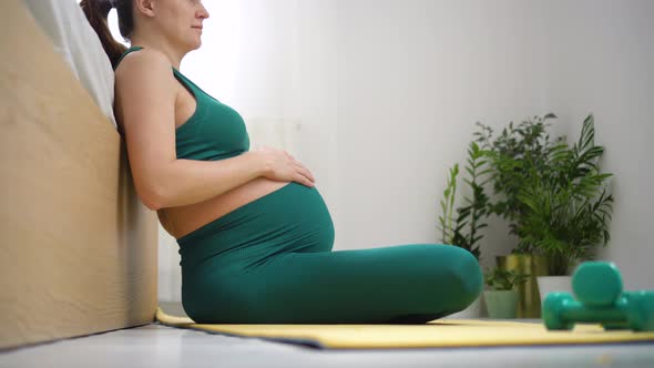 A Pregnant Woman is Prepaexercising with Breath