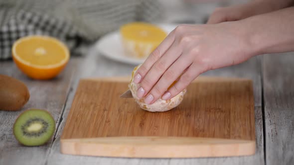 Closeup of Cut Orange Fruit on Wooden Cutting Board