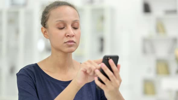 Portrait of Attractive African Woman Using Smartphone 