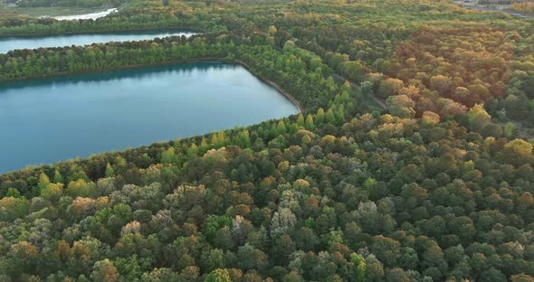 Landscape panorama, blue water in a forest lake with green forests trees