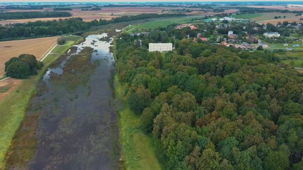 Aerial Shot City Mezotne, Latvia Republic. Mezotne Palace and Park With Fountain. Lielupe River With