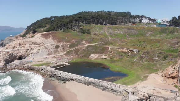 Wide aerial panning shot of the remains of the Sutro Baths at Land's End in San Francisco. 4K