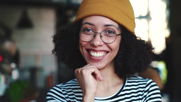 Laughing woman wearing hat looking at the camera