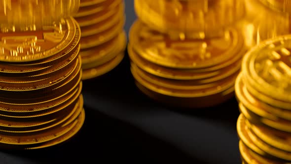 Rising stacks of golden bitcoins BTC. Wealth, cryptocurrency, virtual money.
