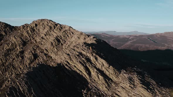 Mountaineer standing on ridge of Puebla de la Sierra Mountains, Spain