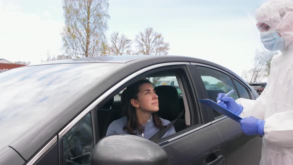 Healthcare Worker with Clipboard and Woman in Car