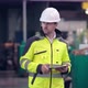 Engineer in Hard Hat is Moving Through a Heavy Industry Factory with a Tablet Computer - VideoHive Item for Sale