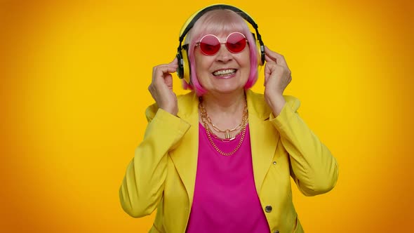 Elderly Woman Listening Music on Headphones Dancing Disco Fooling Having Fun Gesticulating Hands