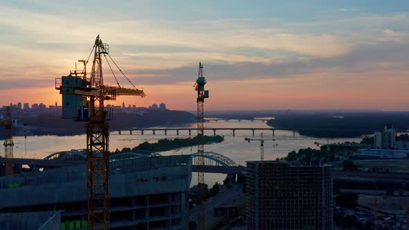 Aerial Horizontal Flight Over Construction Site at Delightful Sunset