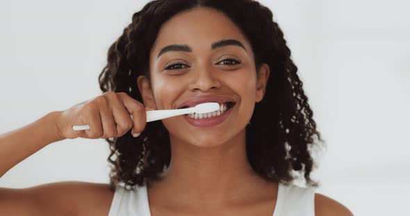 Portrait of Young Cheerful African American Lady Brushing Her Perfect Teeth, Slow Motion