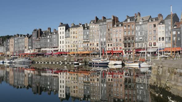 HONFLEUR, FRANCE - SEPTEMBER 2016 Beautiful reflections of buildings and boats in Normandy The Vieux