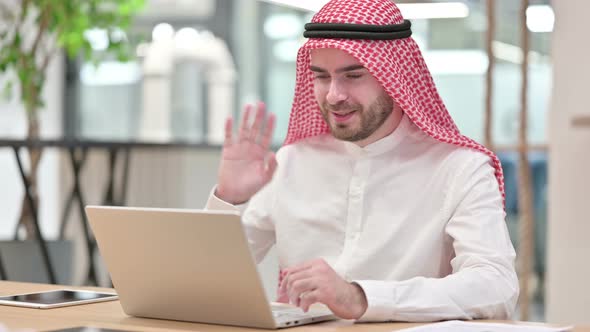 Hardworking Arab Businessman Doing Video Call on Laptop in Office 