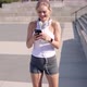 Cheerful Sportswoman Using Smartphone on Street - VideoHive Item for Sale
