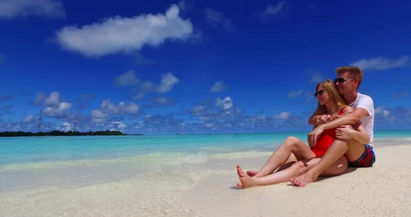 Happy boy and girl on honeymoon vacation enjoy luxury on beach on paradise white sand background 
