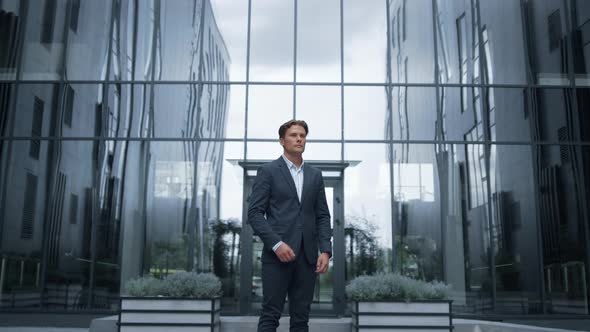 Serious Businessman Standing Outdoors Inspect Downtown District