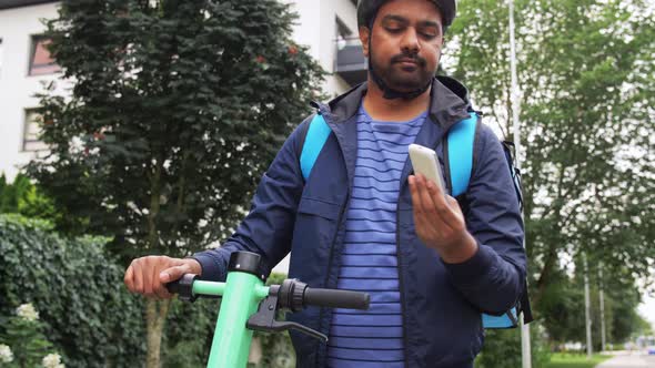 Delivery Man with Phone and Bag Riding Scooter